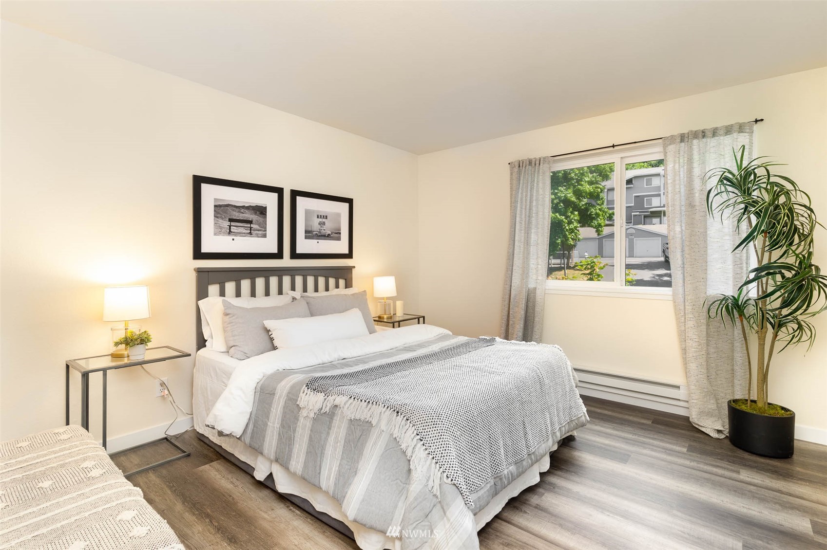 3921 243rd Place Southeast, Unit J204 Bothell, WA 98021 - Photo 14 of 22 a bedroom with a bed and a potted plant