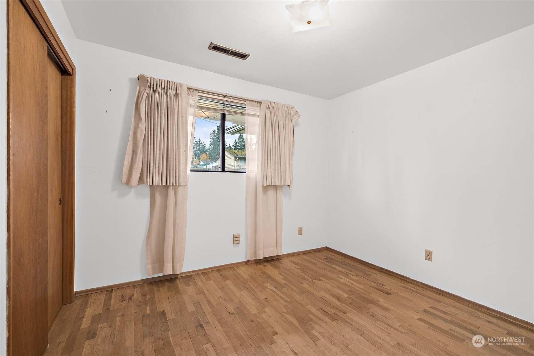 14530 Southeast 112th Place Renton, WA 98059 - Photo 13 of 34 an empty room with wooden floor and windows