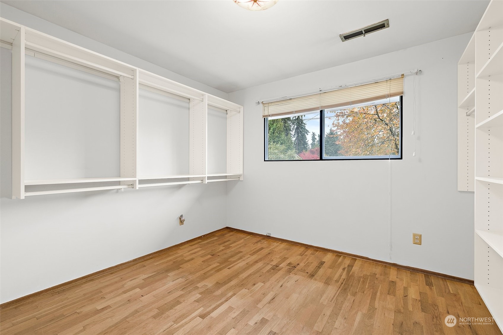 14530 Southeast 112th Place Renton, WA 98059 - Photo 14 of 34 an empty room with wooden floor and windows