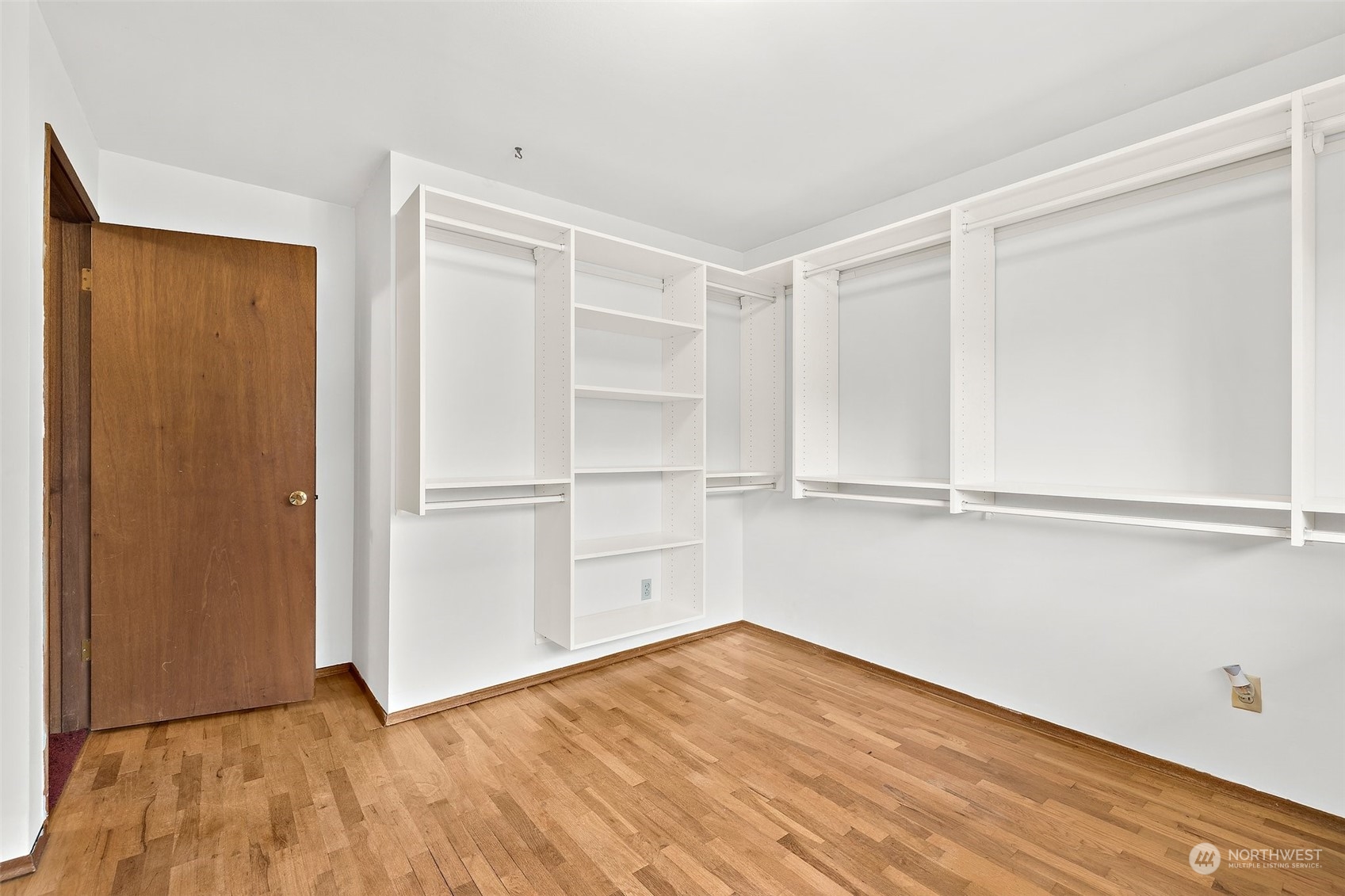 14530 Southeast 112th Place Renton, WA 98059 - Photo 15 of 34 a view of an empty room with closet and wooden floor