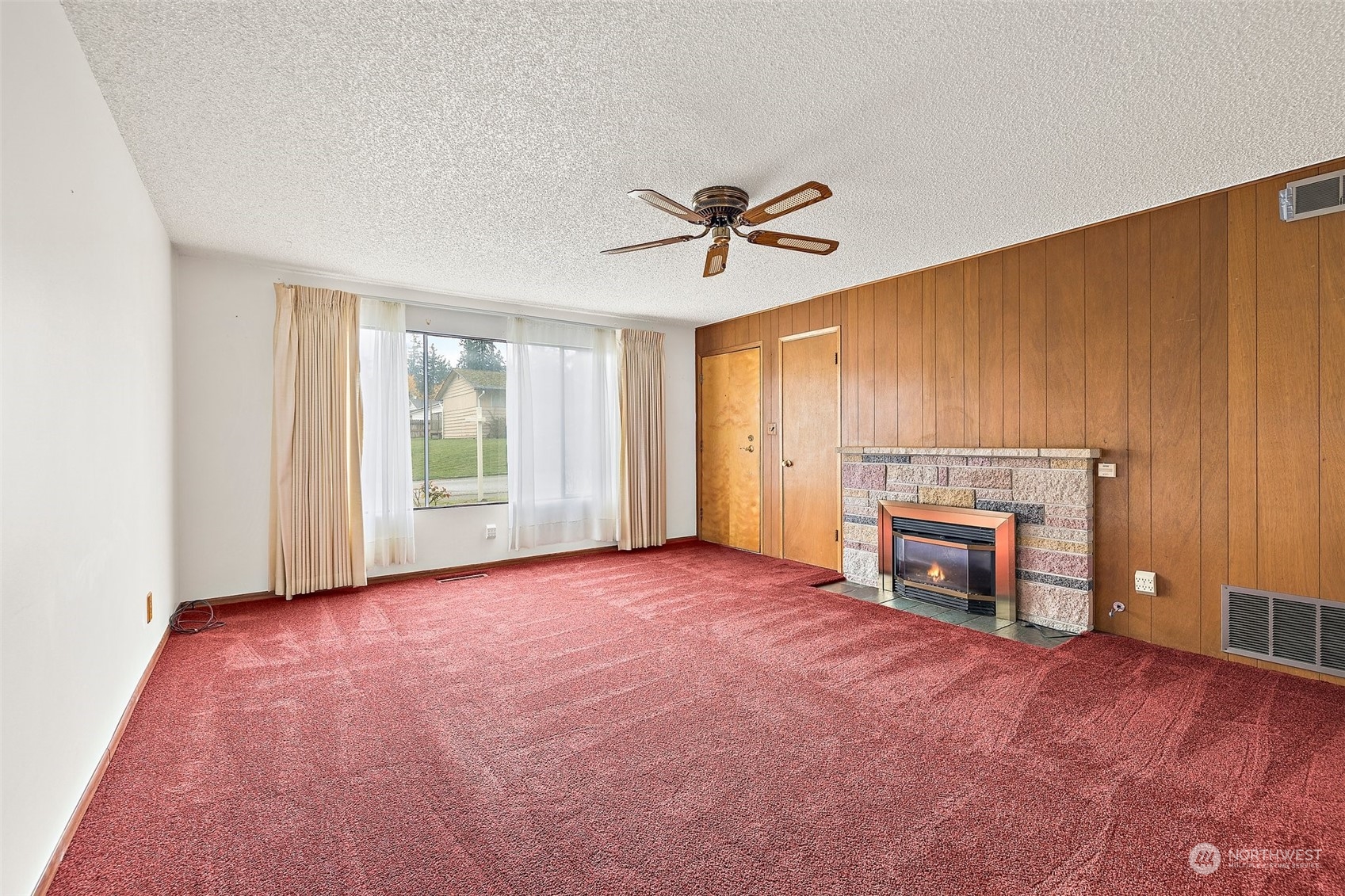 14530 Southeast 112th Place Renton, WA 98059 - Photo 3 of 34 a view of an empty room with a fireplace and a window