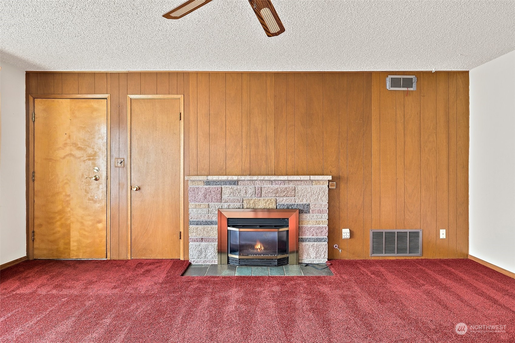 14530 Southeast 112th Place Renton, WA 98059 - Photo 4 of 34 an empty room with wooden floor fireplace and windows