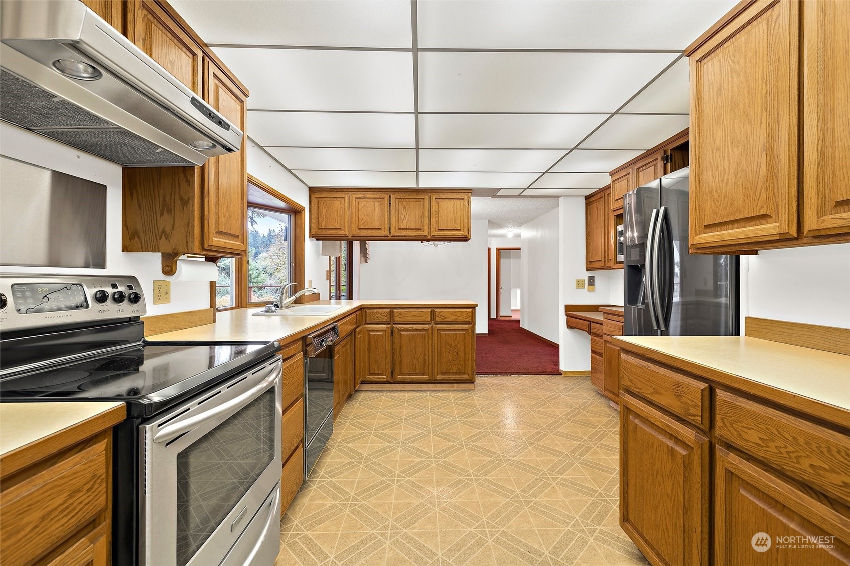 14530 Southeast 112th Place Renton, WA 98059 - Photo 10 of 34 a kitchen with stainless steel appliances granite countertop a sink and wooden cabinets