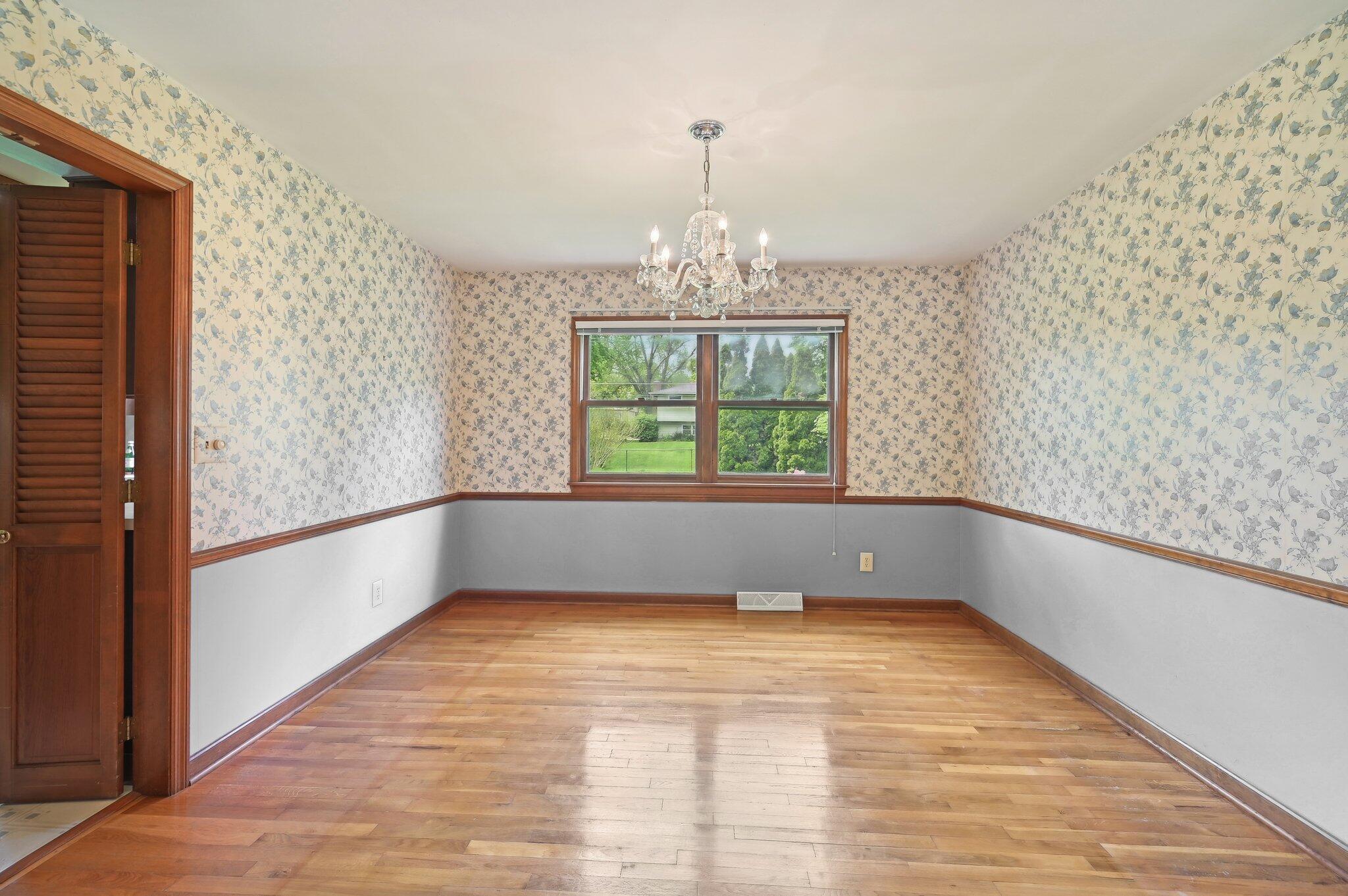 5917 Rocky Rill Road Columbus, OH 43235 - Photo 18 of 47 Dining Room with Chandelier
Formal dining room with hardwood flooring, chandelier lighting, and wallpaper accent walls. Window offers views of the backyard.