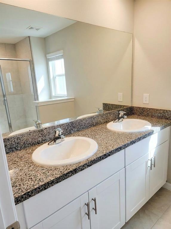 14308 Easy Goer Street Ruskin, FL 33573 - Photo 7 of 14 a bathroom with a granite countertop double sink and a mirror