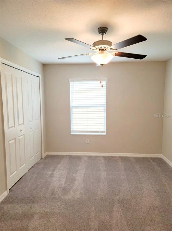 14308 Easy Goer Street Ruskin, FL 33573 - Photo 8 of 14 a view of an empty room with a window