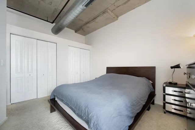 a bedroom with a bed and a cabinets