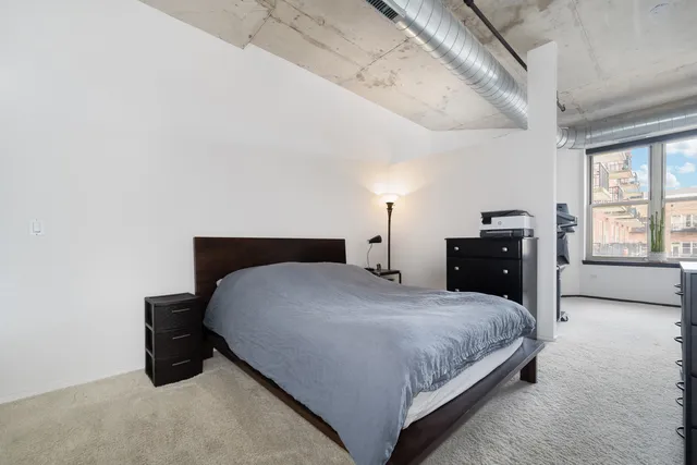 a bedroom with a bed and dresser