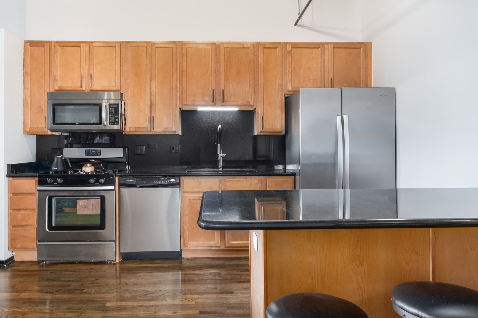 6 South Laflin Street, Unit 722 Chicago, IL 60607 - Photo 9 of 16 a kitchen with a refrigerator and a stove top oven
