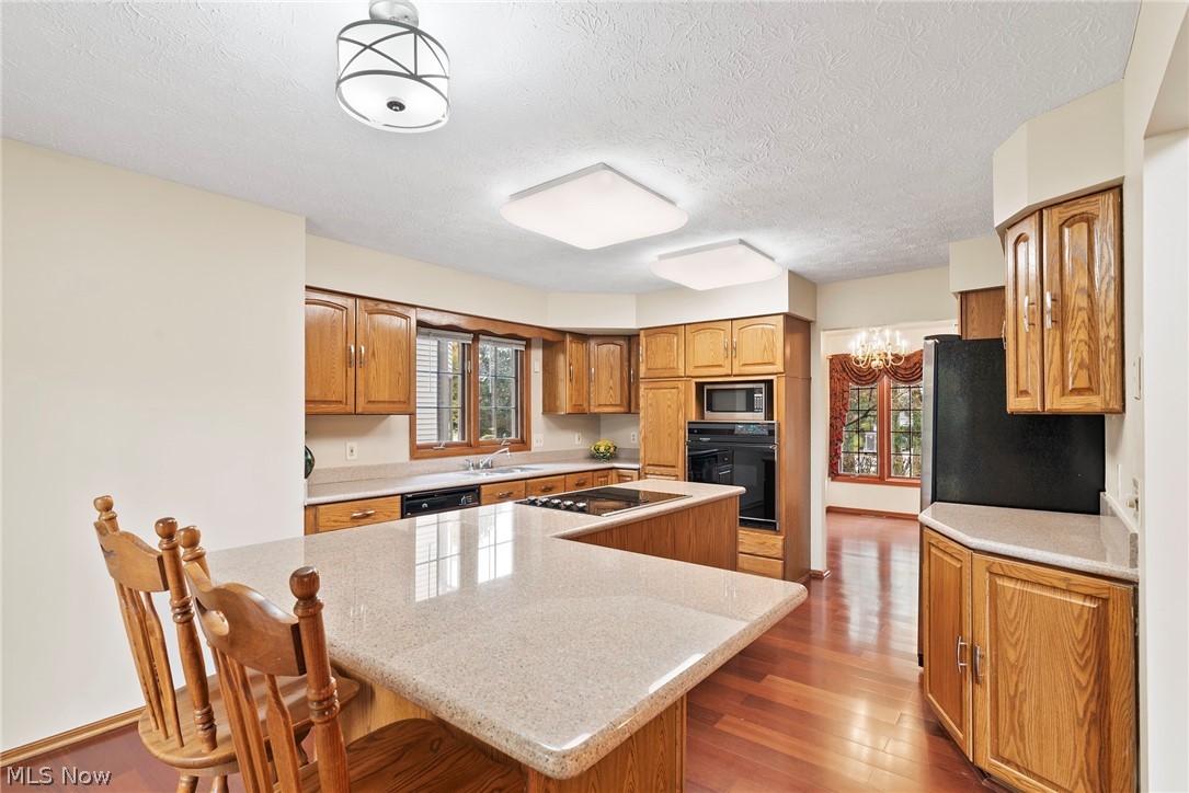 31325 Arthur Road Solon, OH 44139 - Photo 6 of 32 Kitchen view with granite counter tops hardwood flooring. All appliances stay including newer cooktop, and new cabinet hardware.