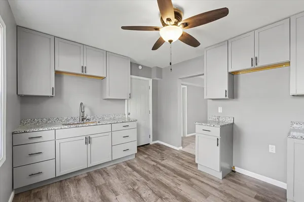 a kitchen with stainless steel appliances granite countertop a sink a stove and refrigerator