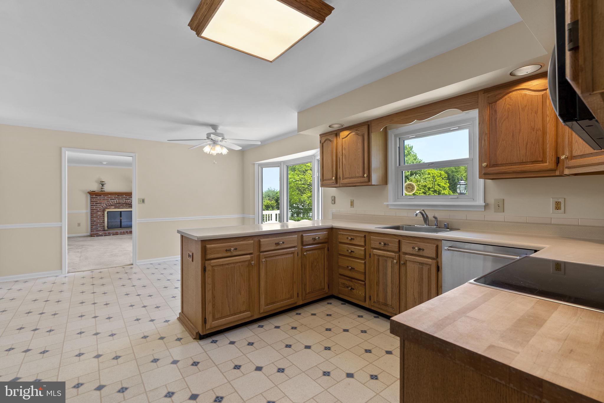17513 Country View Way Mount Airy, MD 21771 - Photo 14 of 59 a kitchen with stainless steel appliances kitchen island granite countertop a sink and cabinets