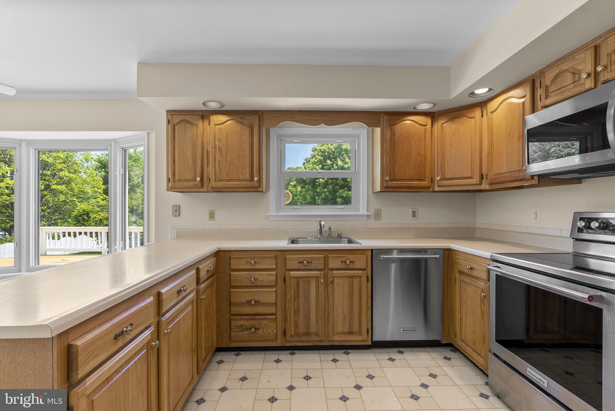 17513 Country View Way Mount Airy, MD 21771 - Photo 15 of 59 a kitchen with stainless steel appliances a sink a stove and cabinets