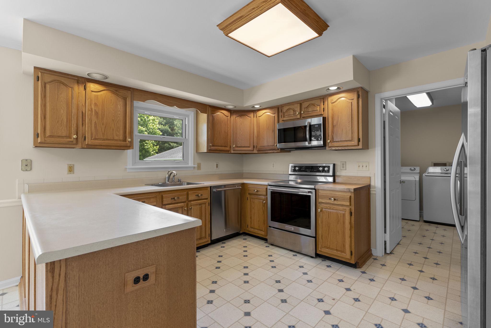 17513 Country View Way Mount Airy, MD 21771 - Photo 18 of 59 a kitchen with stainless steel appliances a stove sink microwave and cabinets