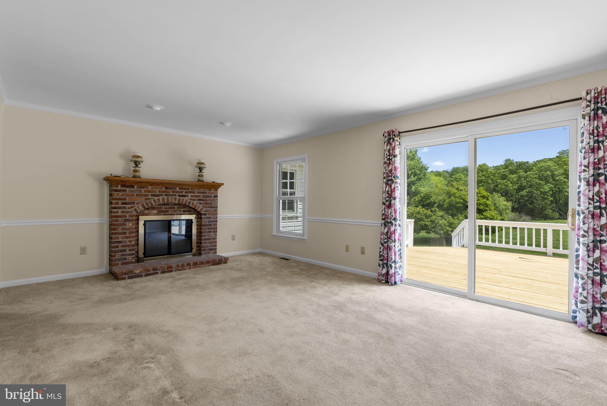 17513 Country View Way Mount Airy, MD 21771 - Photo 23 of 59 a view of an empty room with a fireplace and a window