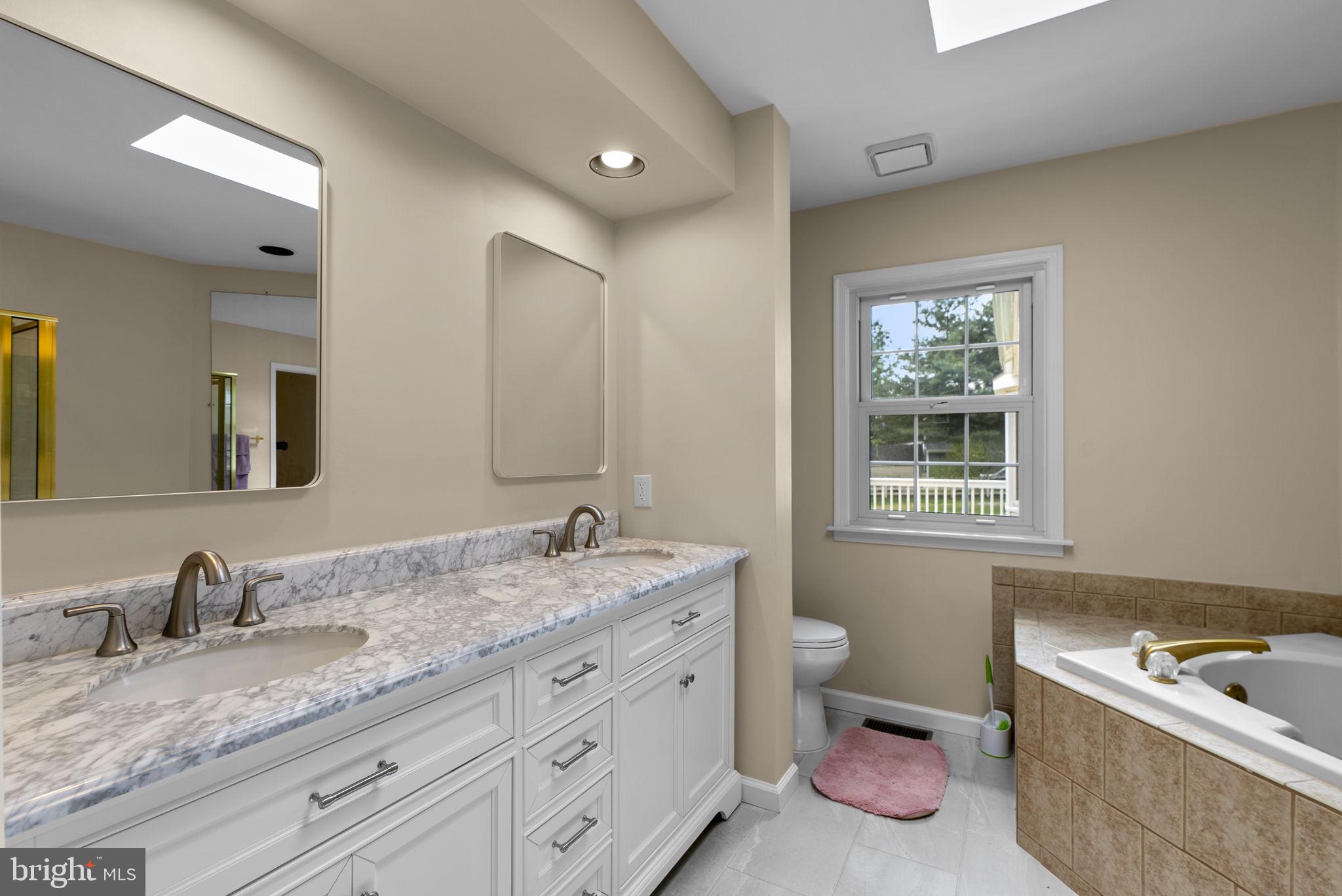 17513 Country View Way Mount Airy, MD 21771 - Photo 30 of 59 a spacious bathroom with a granite countertop double vanity sink a mirror and a