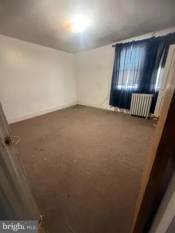 an empty room with wooden floor