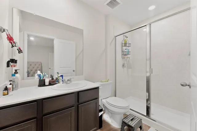 a bathroom with a sink toilet and shower