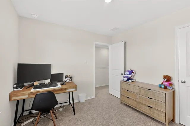 a view of a workspace with furniture and a flat screen tv