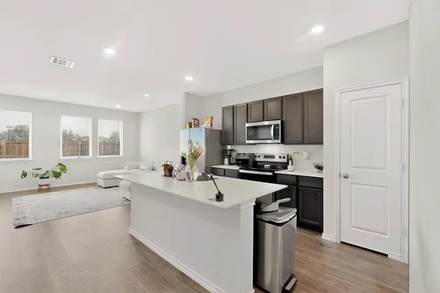 a kitchen with a sink stainless steel appliances and cabinets