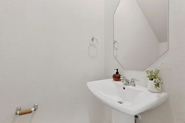 a bathroom with a sink and mirror