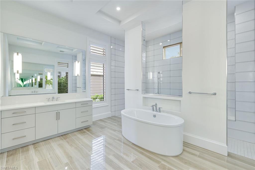 9937 Montiano Court Naples, FL 34113 - Photo 12 of 25 a bathroom with a bathtub and a sink