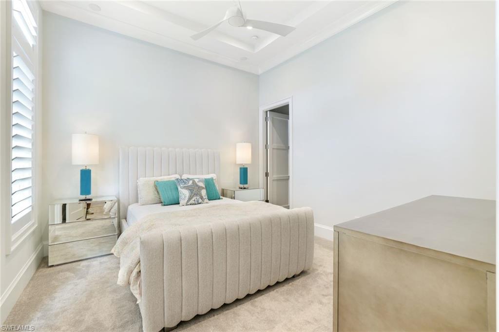9937 Montiano Court Naples, FL 34113 - Photo 17 of 25 a bedroom with a bed and a cabinets