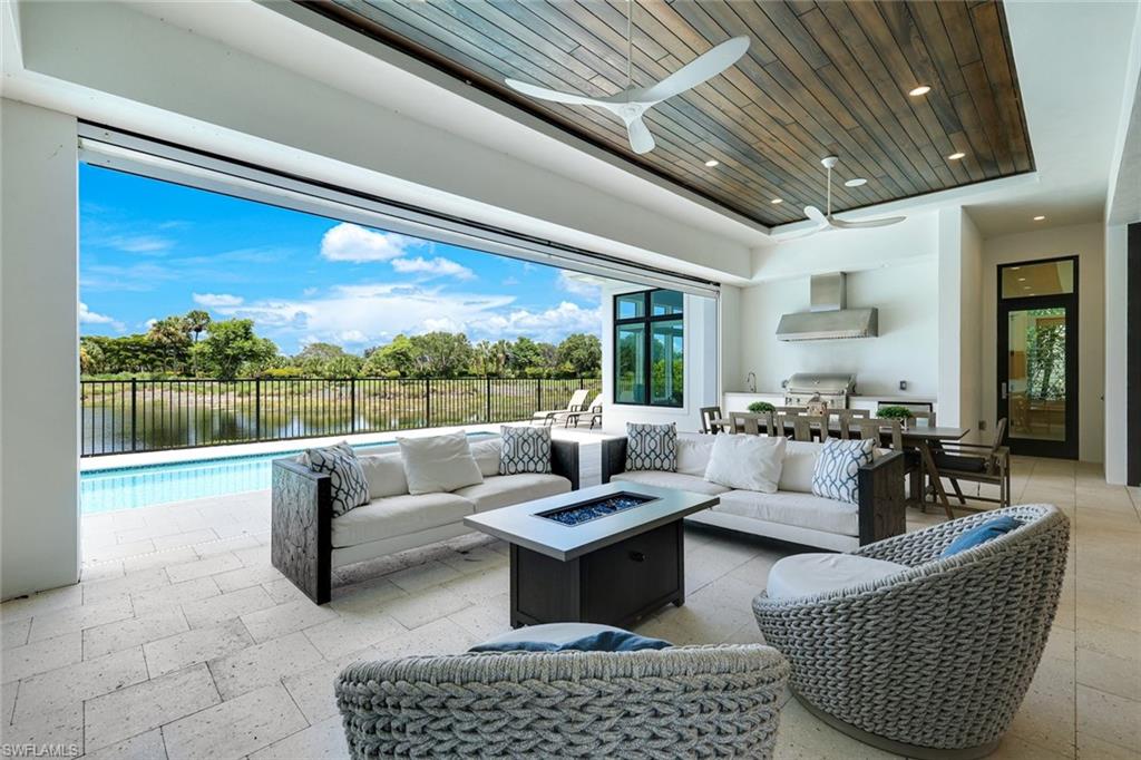 9937 Montiano Court Naples, FL 34113 - Photo 19 of 25 a living room with furniture and a large window