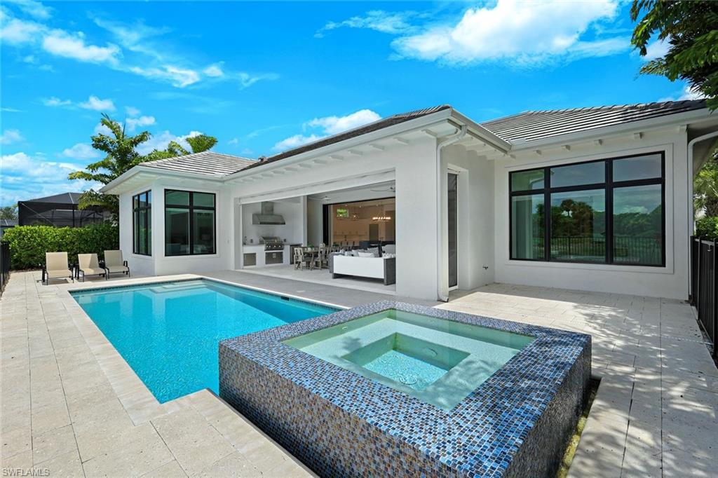 9937 Montiano Court Naples, FL 34113 - Photo 21 of 25 a view of a house with backyard porch and sitting area