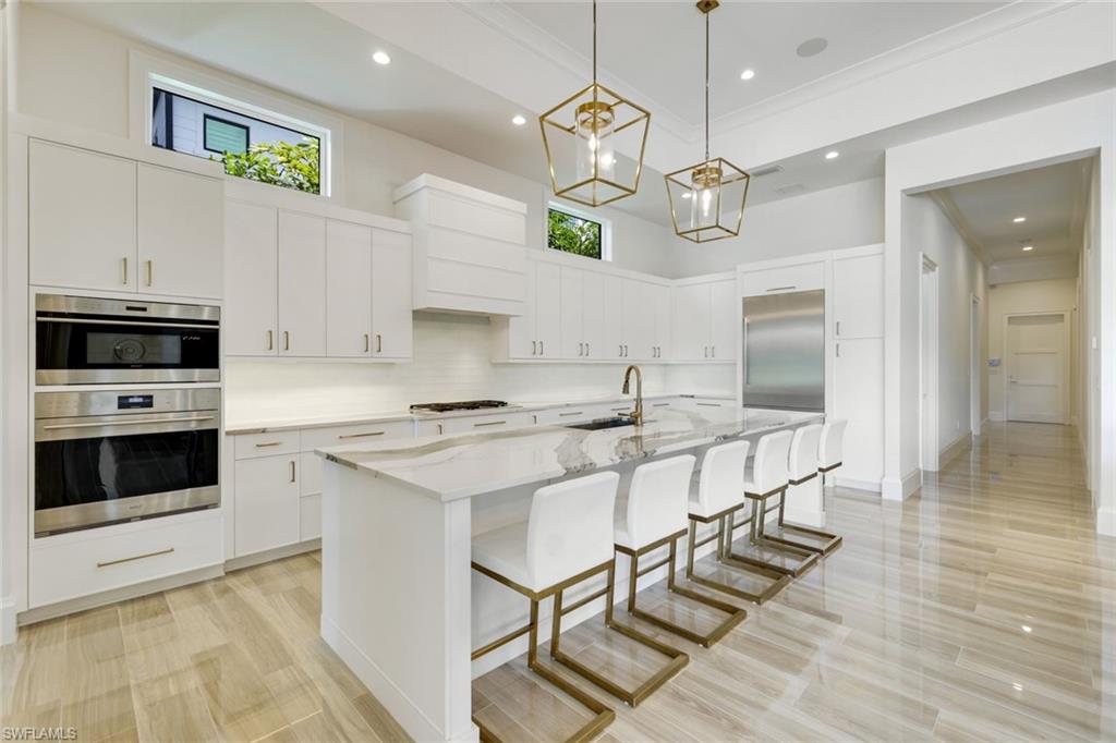 9937 Montiano Court Naples, FL 34113 - Photo 7 of 25 a kitchen with a counter space cabinets and stainless steel appliances