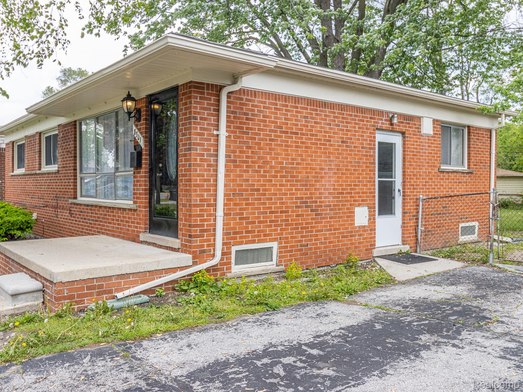 8501 Allen Road Allen Park, MI 48101 - Photo 26 of 27 View of side of home featuring brick siding and a gate