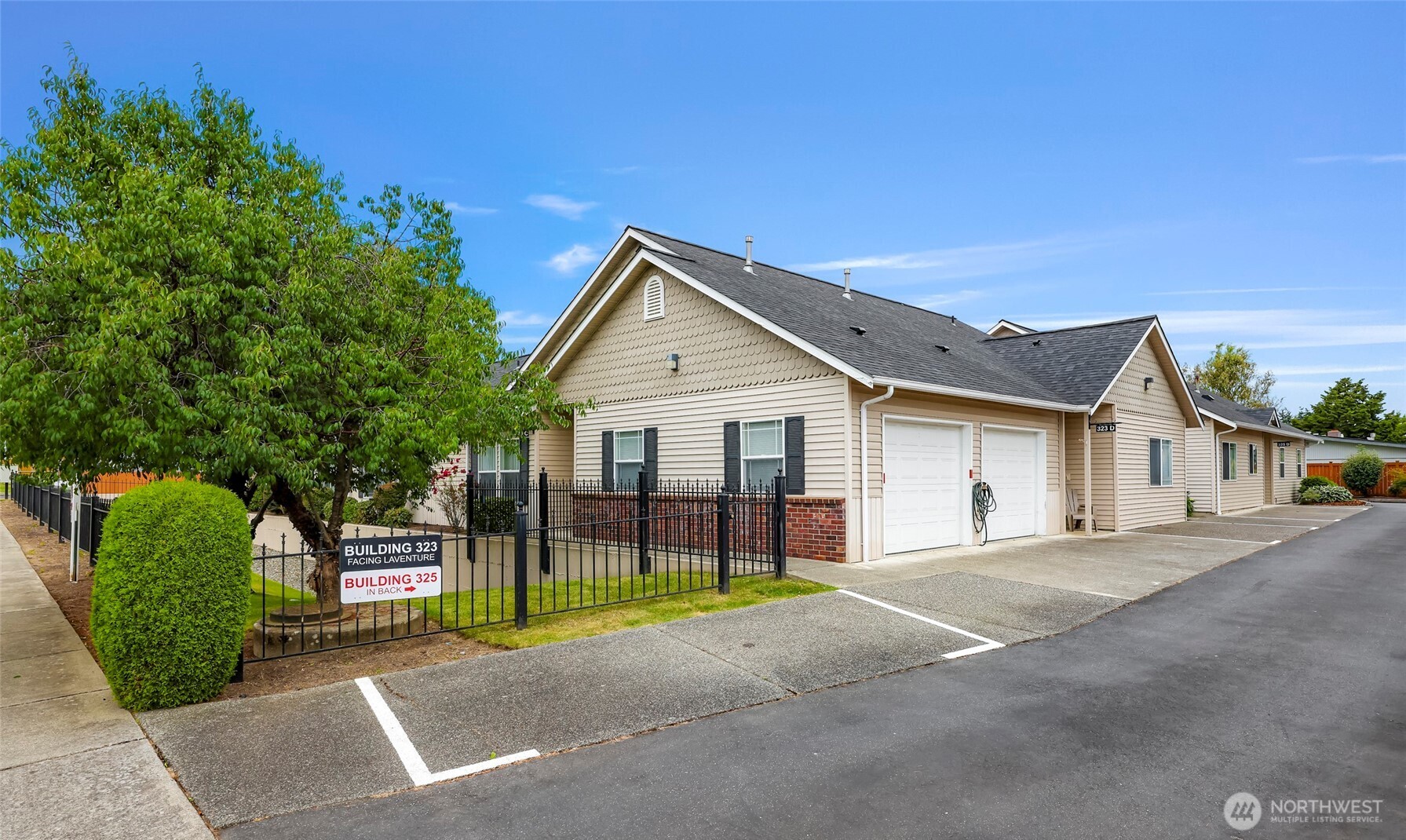 a view of a house with a yard and potted plants