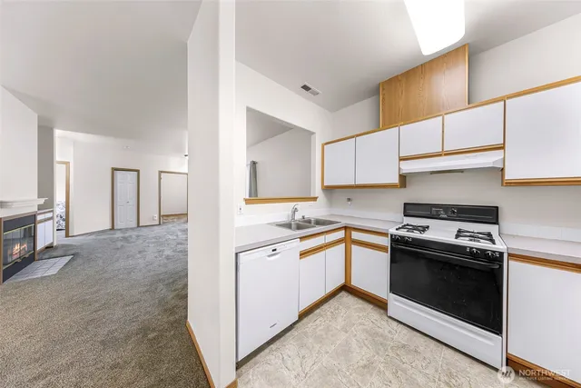 a kitchen with stainless steel appliances granite countertop a stove and a sink