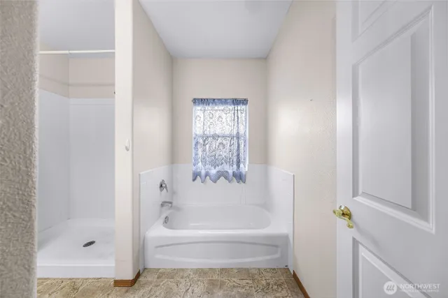 a bathroom with a bathtub and a shower