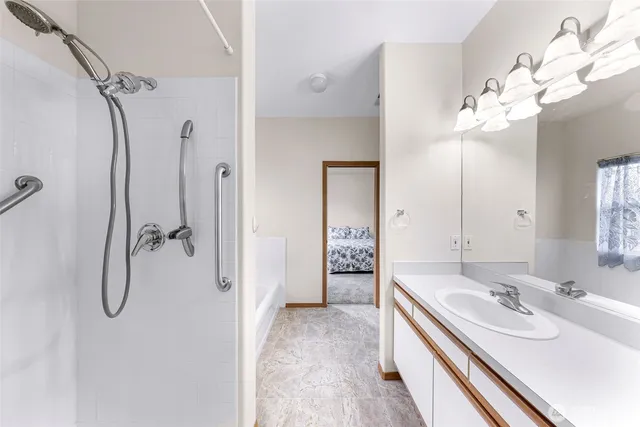 a bathroom with a double vanity sink mirror and shower