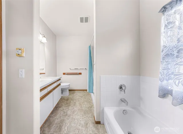 a bathroom with a bathtub sink and toilet
