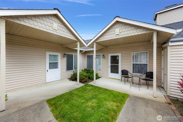 a view of backyard with table and chairs and potted plants