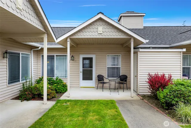 a front view of house with outdoor seating and yard