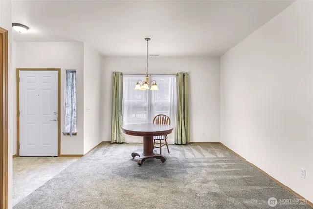 a view of an empty room with a birdcage and a window