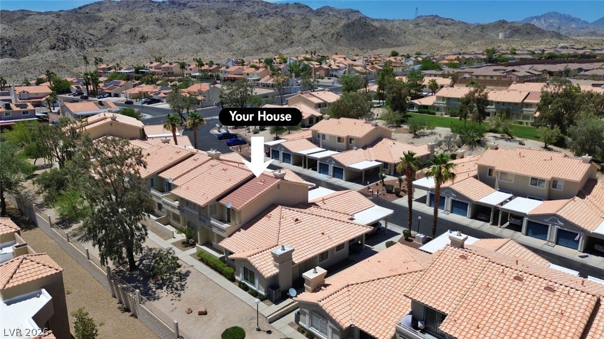 2243 Rugged Mesa Drive Laughlin, NV 89029 - Photo 4 of 32 An aerial perspective reveals a vibrant community nestled against a majestic mountain backdrop.