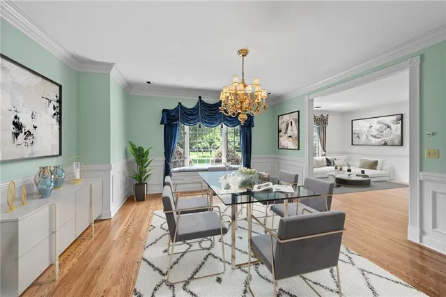 a living room with furniture chandelier and a window