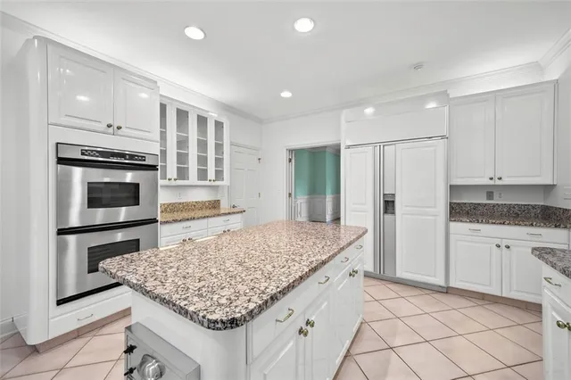 a kitchen with stainless steel appliances granite countertop refrigerator sink and stove