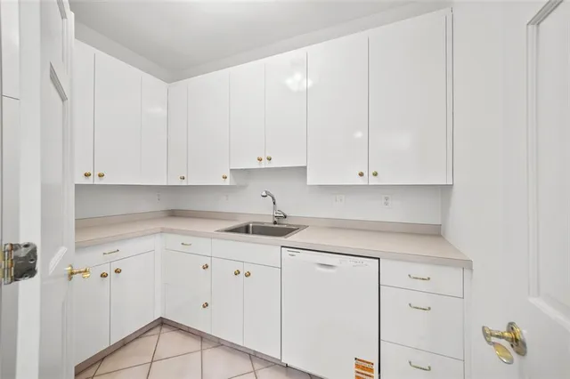 a kitchen with granite countertop white cabinets and white appliances