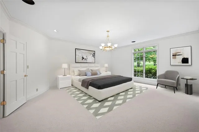 a bedroom with furniture and a large window