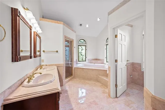 a bathroom with a sink a mirror and a bath tub