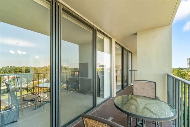 a balcony with table and chairs