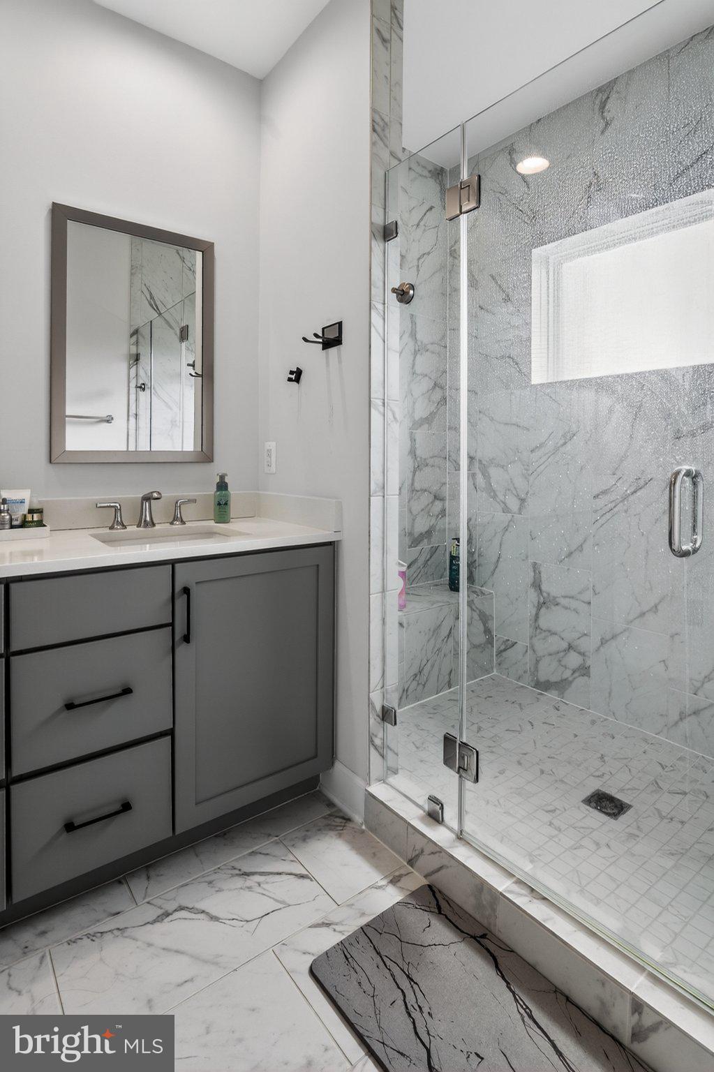 5207 Ridgeview Retreat Drive Chantilly, VA 20151 - Photo 12 of 54 Sleek marble bath with modern elegance.
