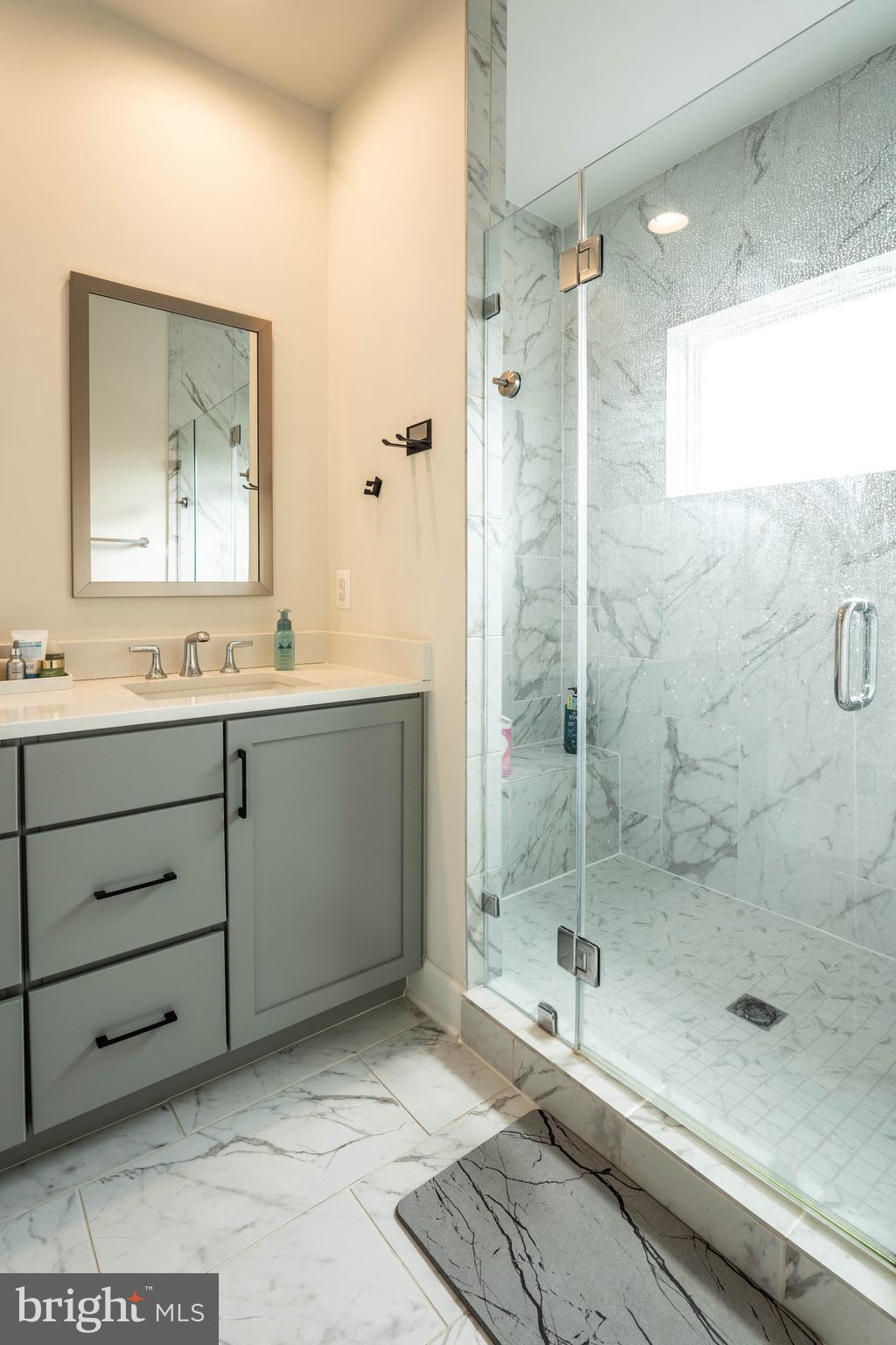 5207 Ridgeview Retreat Drive Chantilly, VA 20151 - Photo 16 of 28 a bathroom with a shower sink and mirror