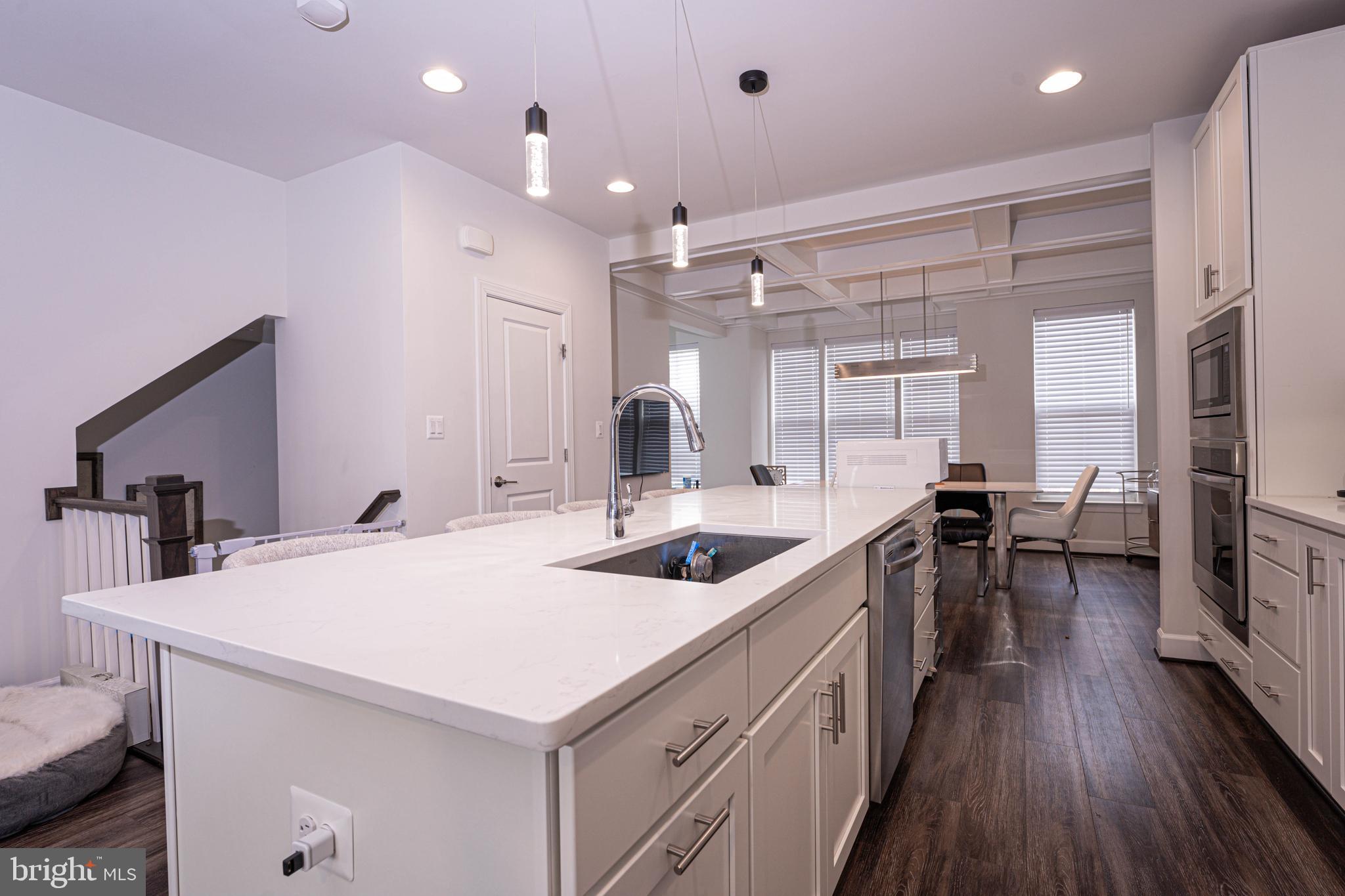 5207 Ridgeview Retreat Drive Chantilly, VA 20151 - Photo 31 of 54 a kitchen with sink cabinets and wooden floor