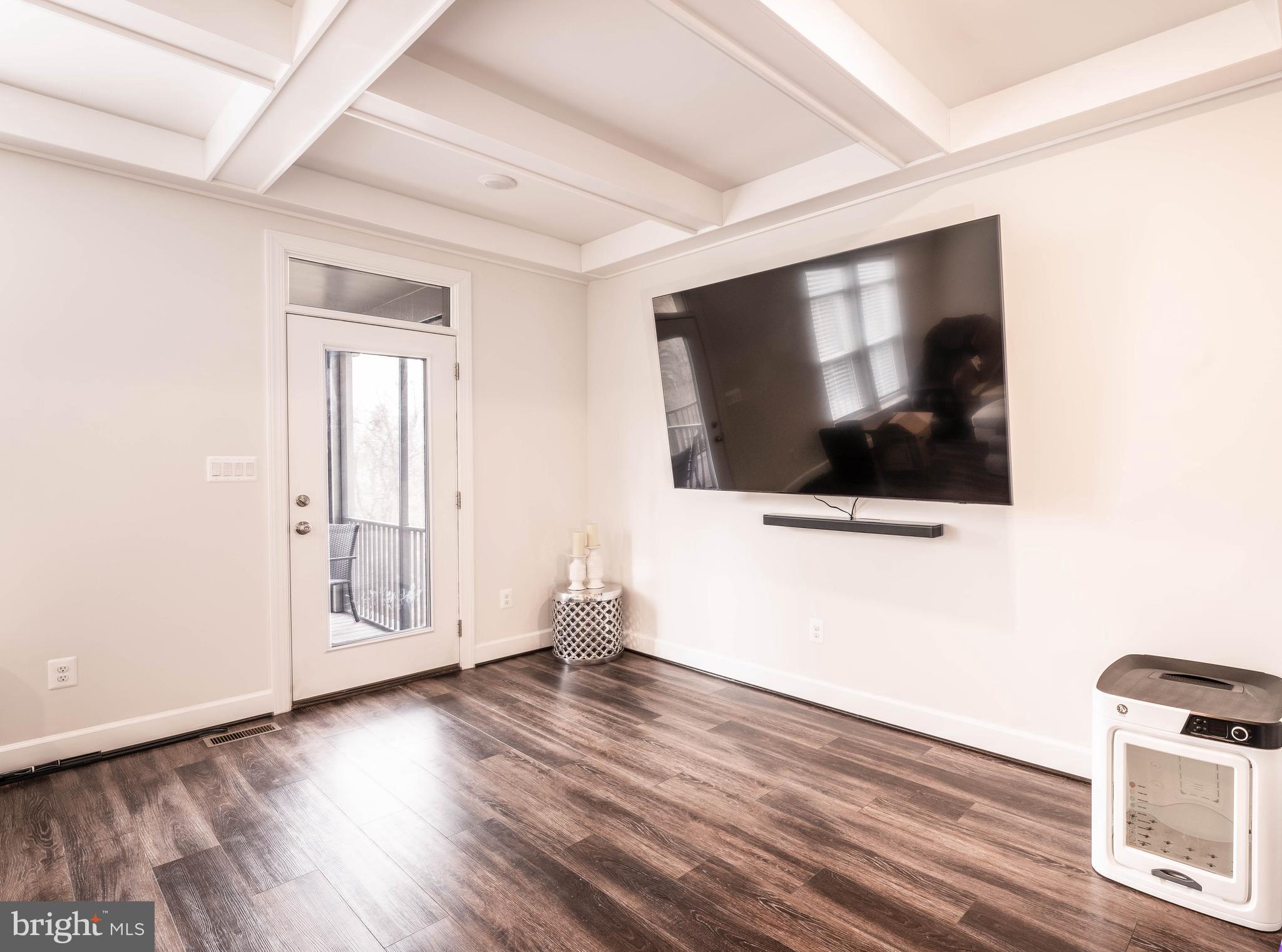 5207 Ridgeview Retreat Drive Chantilly, VA 20151 - Photo 37 of 54 a view of a livingroom with wooden floor and a flat screen tv